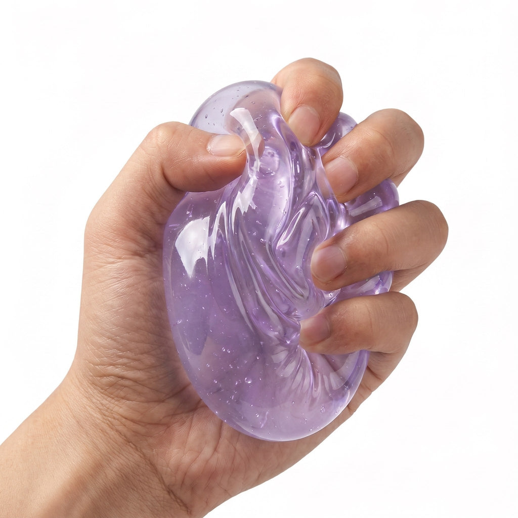 An adult hand mid-squeeze, the purple gel core visibly deformed and holding its shape