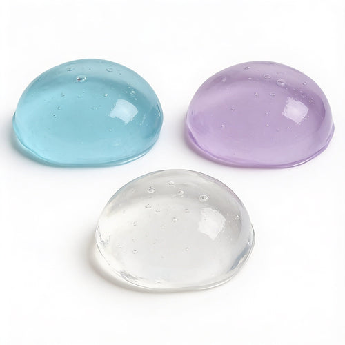 Nyxna Crush gel balls in blue, purple and translucent on a neutral surface
